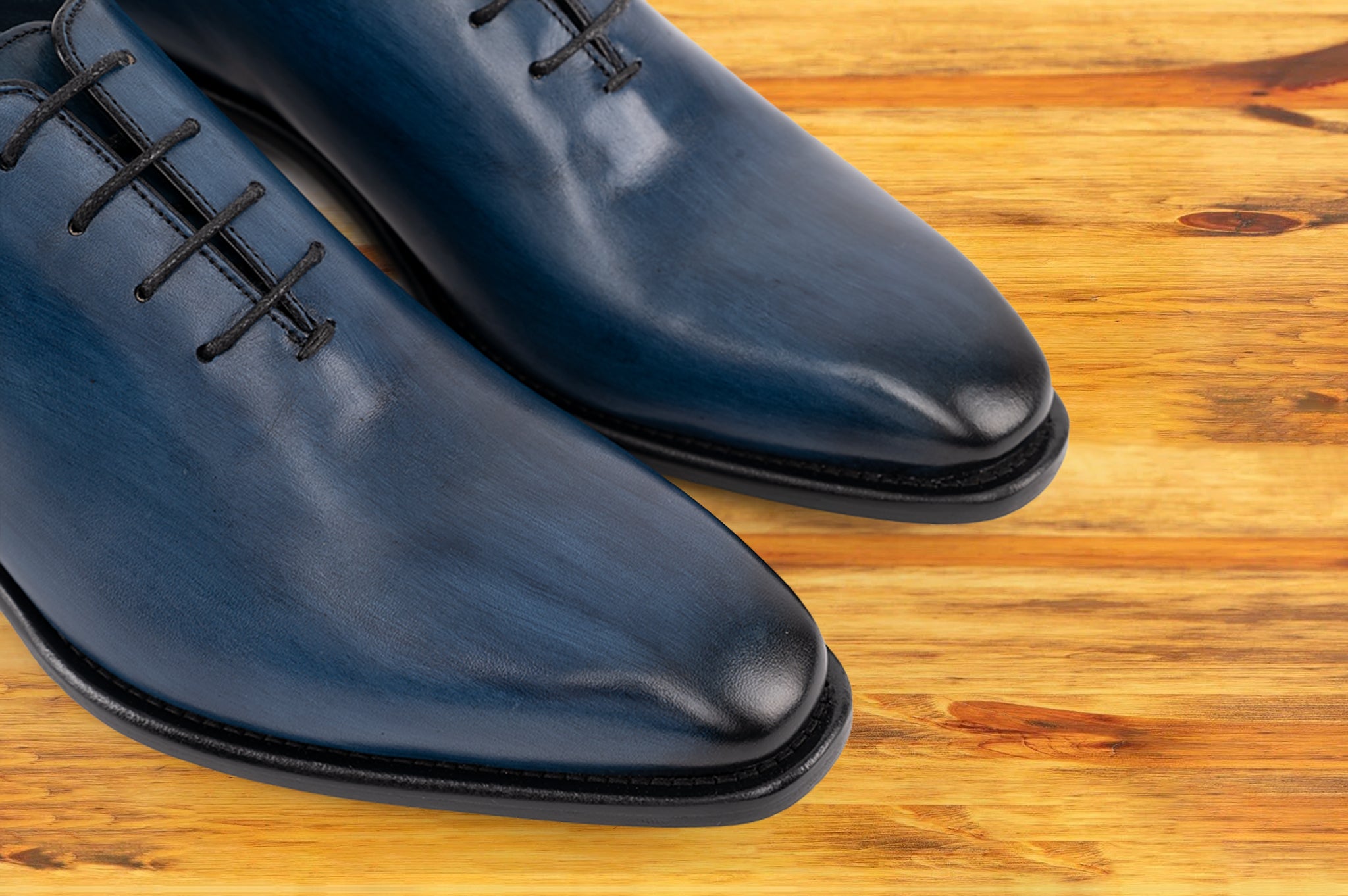 Pair of Blue leather dress shoe on a wooden surface
