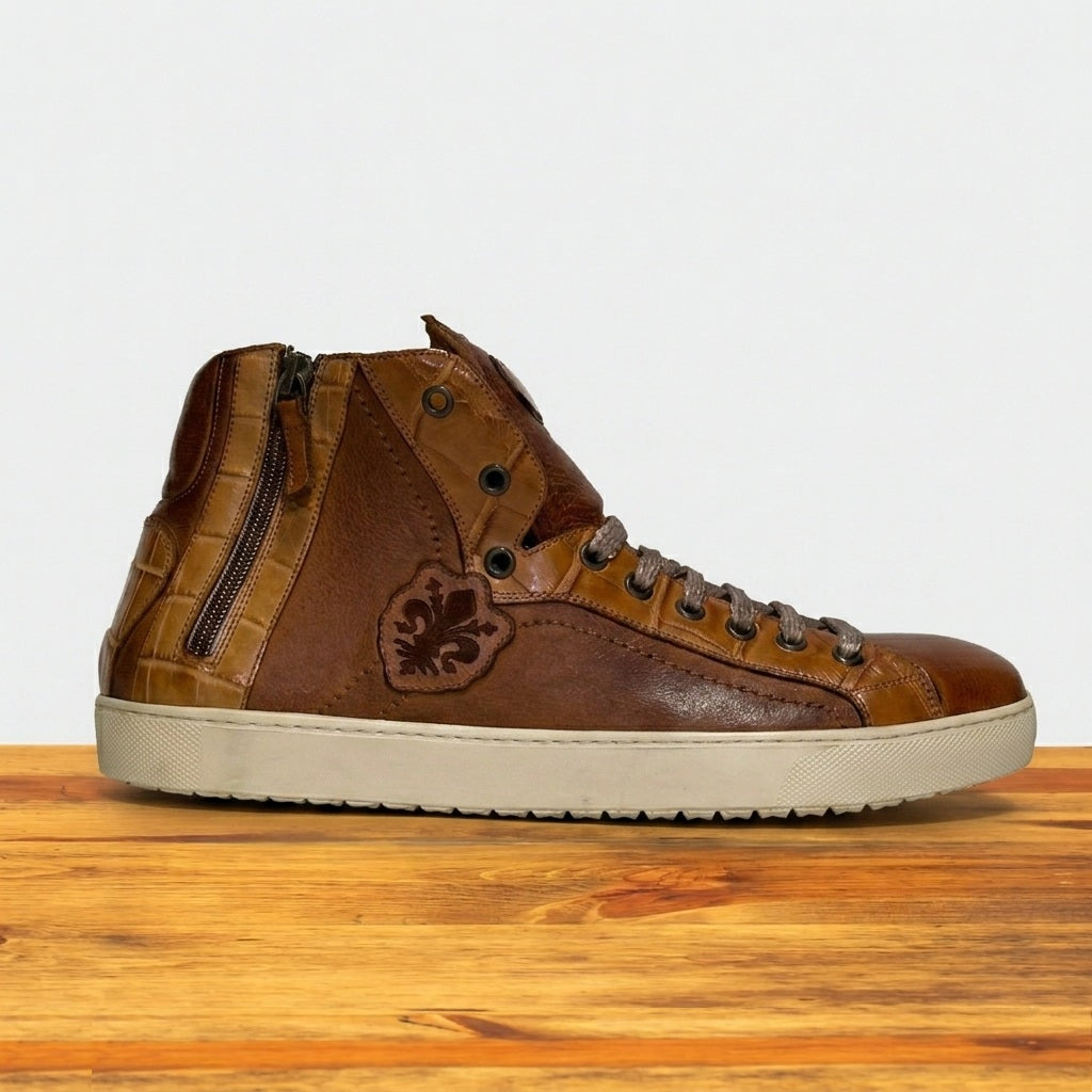 Brown high-top sneaker with a logo on a wooden surface