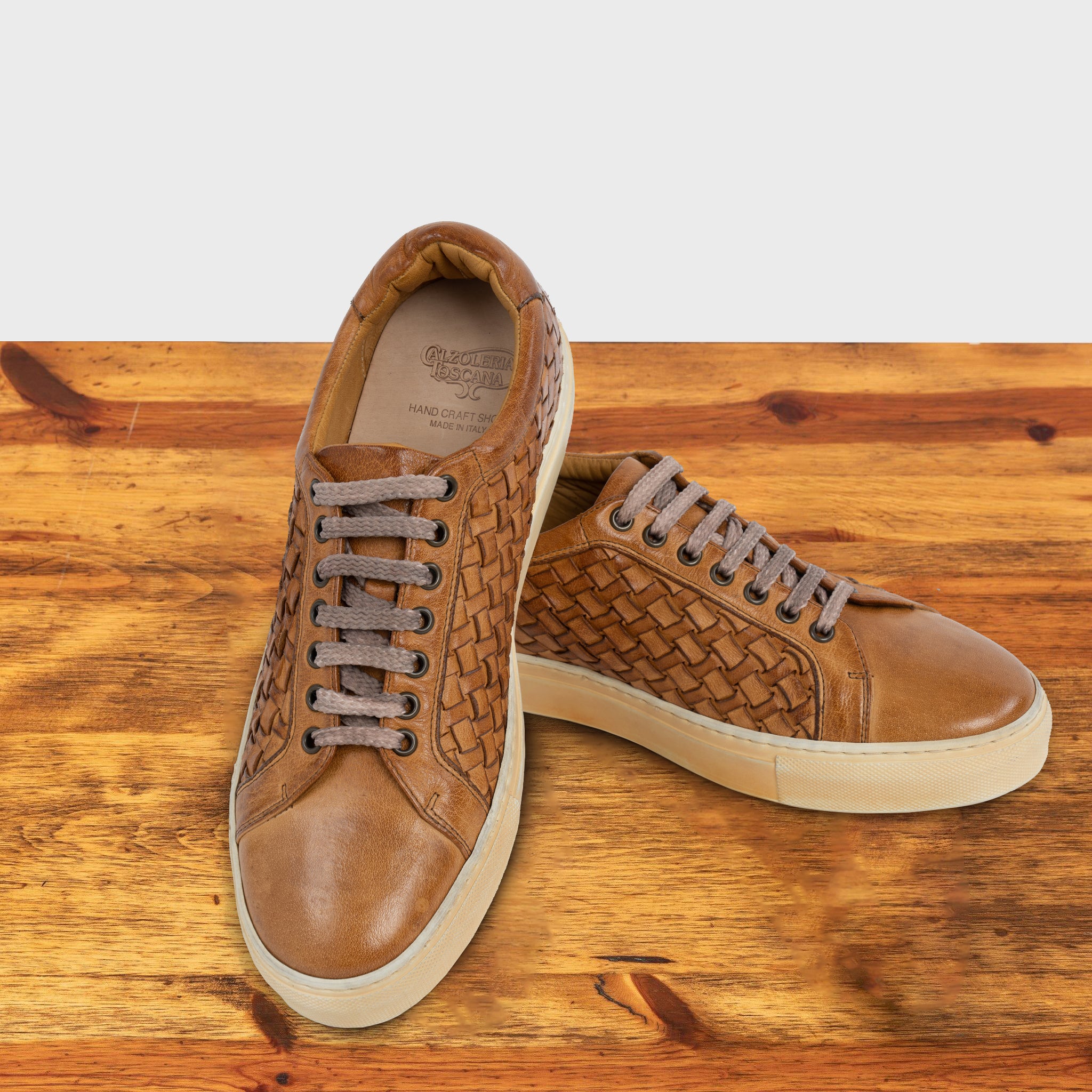 A Pair of Brick woven sneaker on a wooden surface
