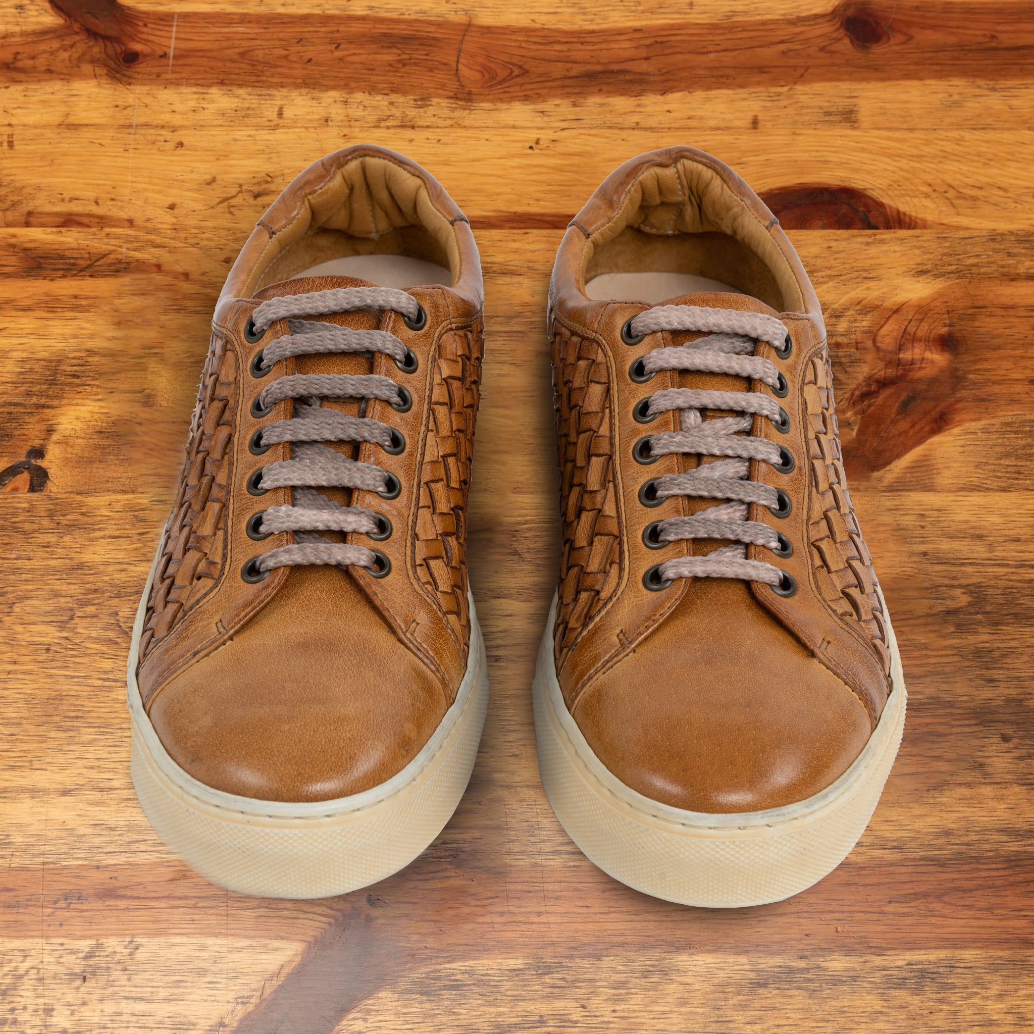 A Pair of Brick woven sneaker on a wooden surface