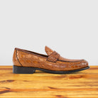 Brick leather loafer on a wooden surface with a light gray background