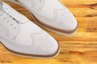 A pair of White shoe on a wooden surface