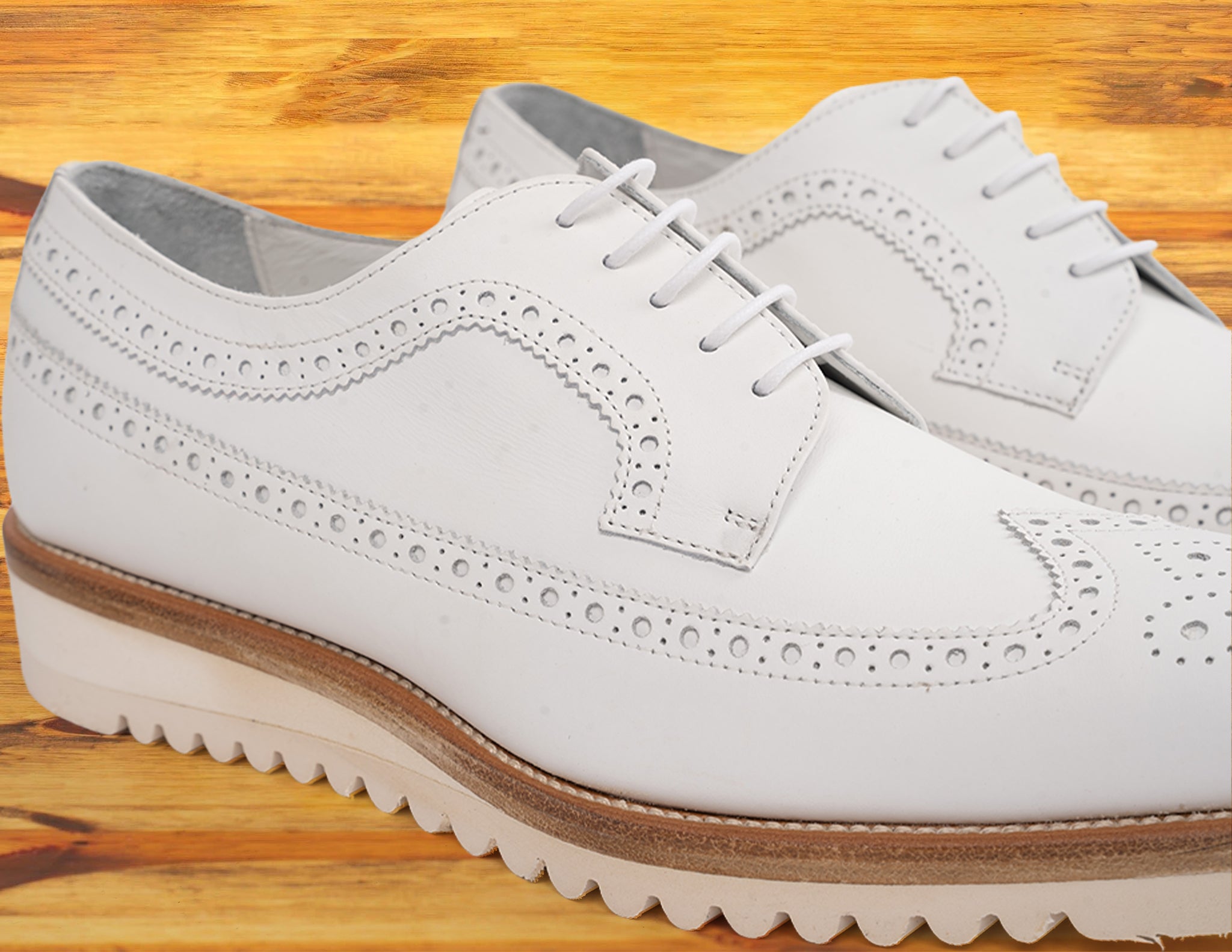 A Pair of White shoe on a wooden surface