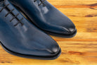 Pair of Blue leather dress shoe on a wooden surface