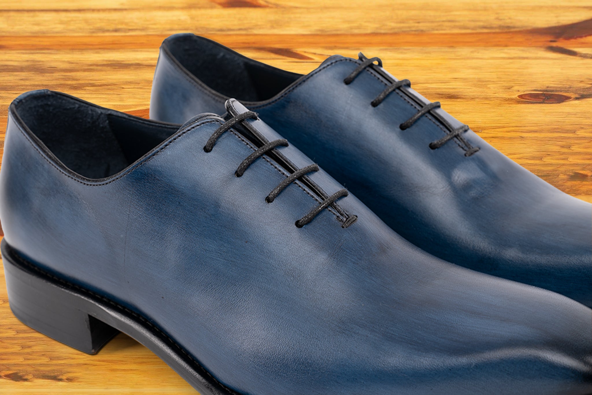 Pair of Blue leather dress shoe on a wooden surface