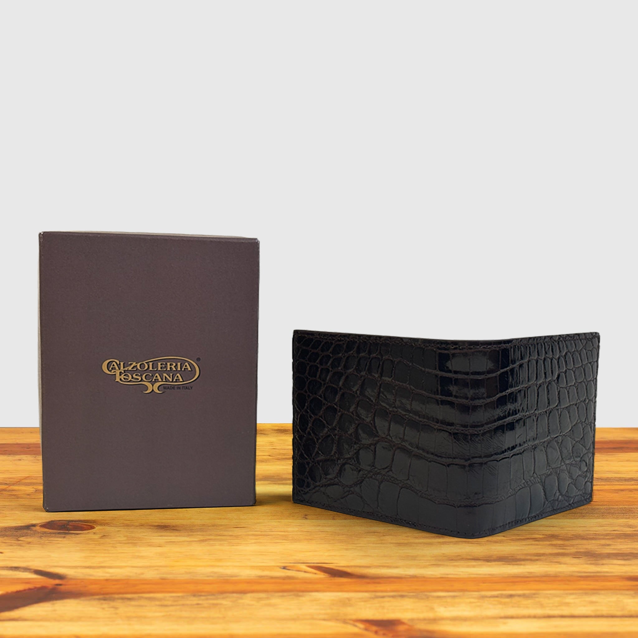 Dark Brown wallet with box at wooden surface