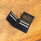 Black wallet with credit cards on a wooden surface