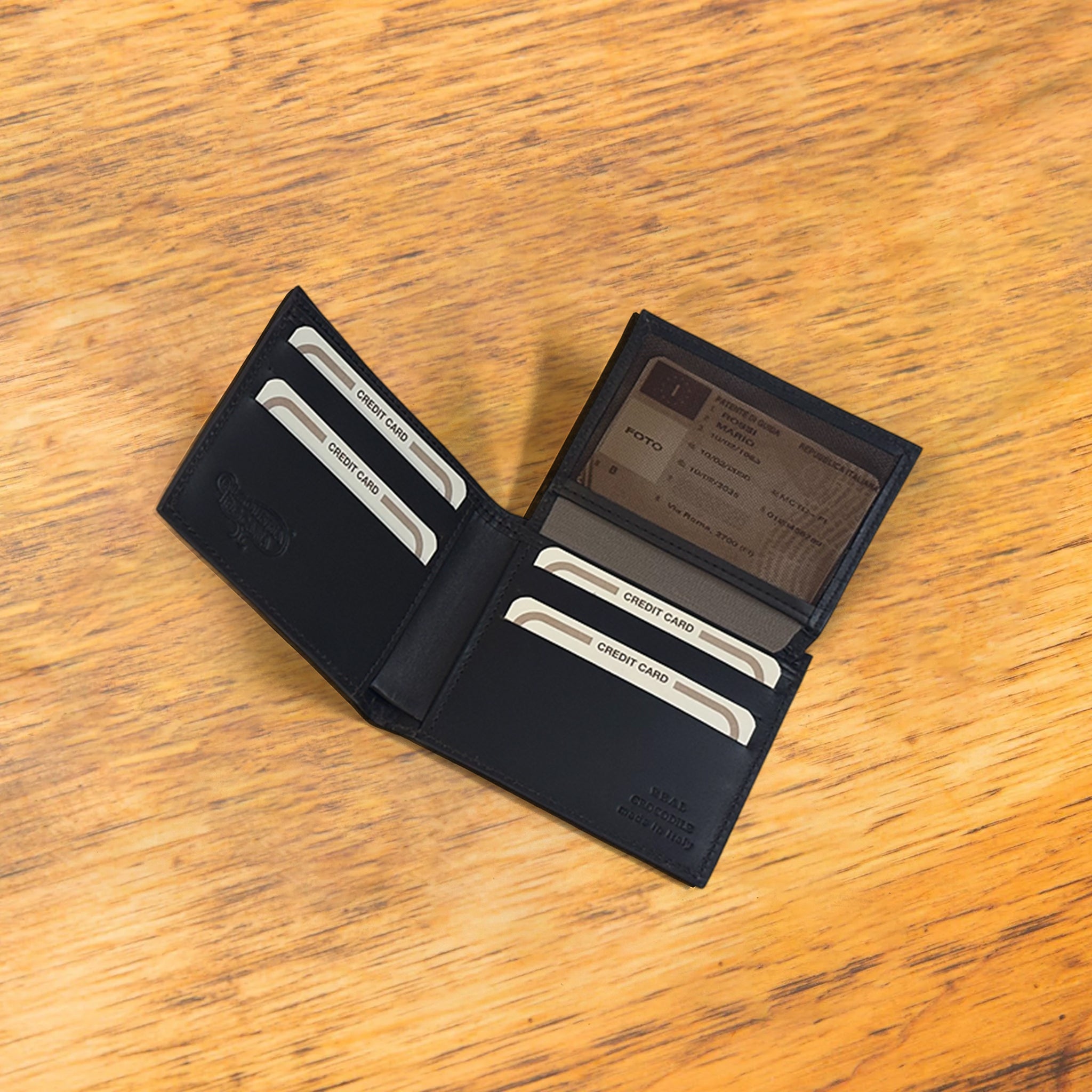 Black wallet with credit cards on a wooden surface