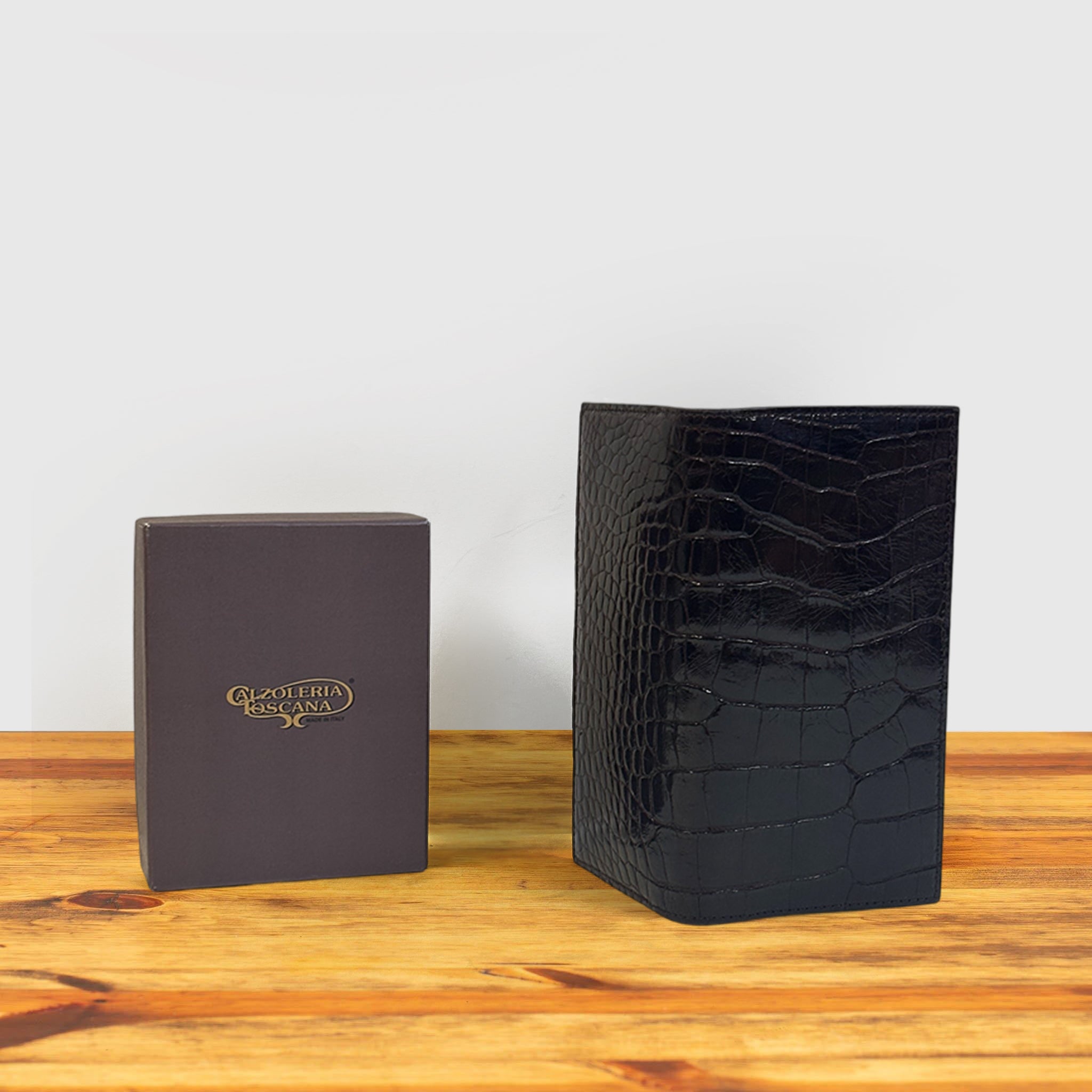 Dark Brown crocodile-patterned wallet and box on a wooden surface