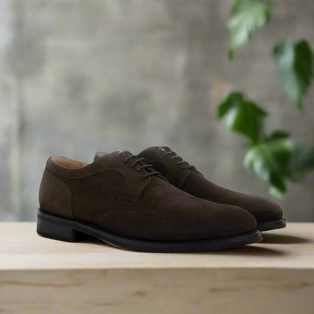A Pair of Charcoal suede dress shoe on a wooden surface