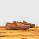 Pair of Brick loafer shoe with woven pattern on a wooden surface