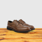 A Pair of Cerris leather shoe on a wooden surface with a light gray background