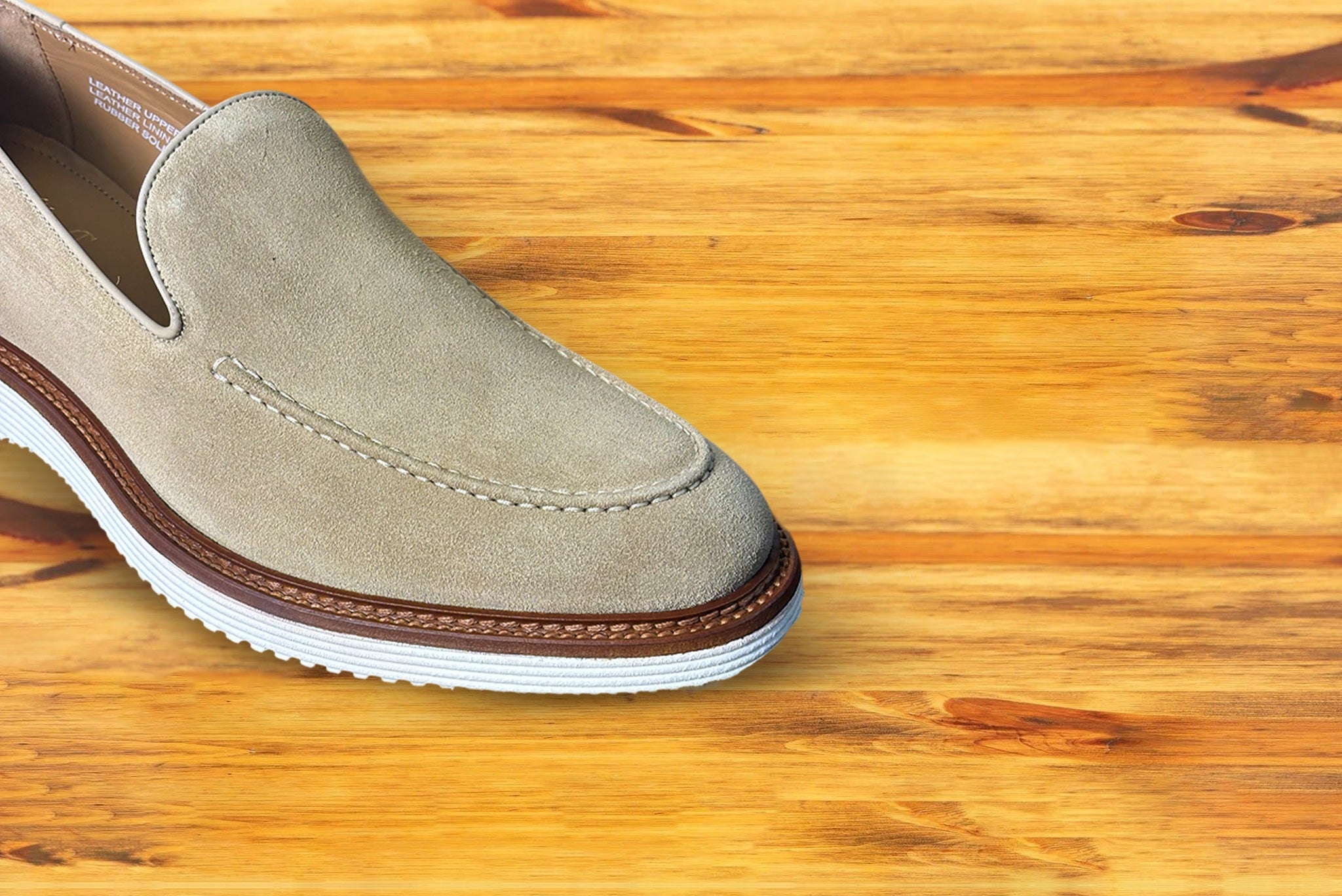 Cream loafer shoe on a wooden surface