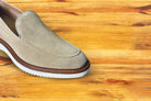 Cream loafer shoe on a wooden surface