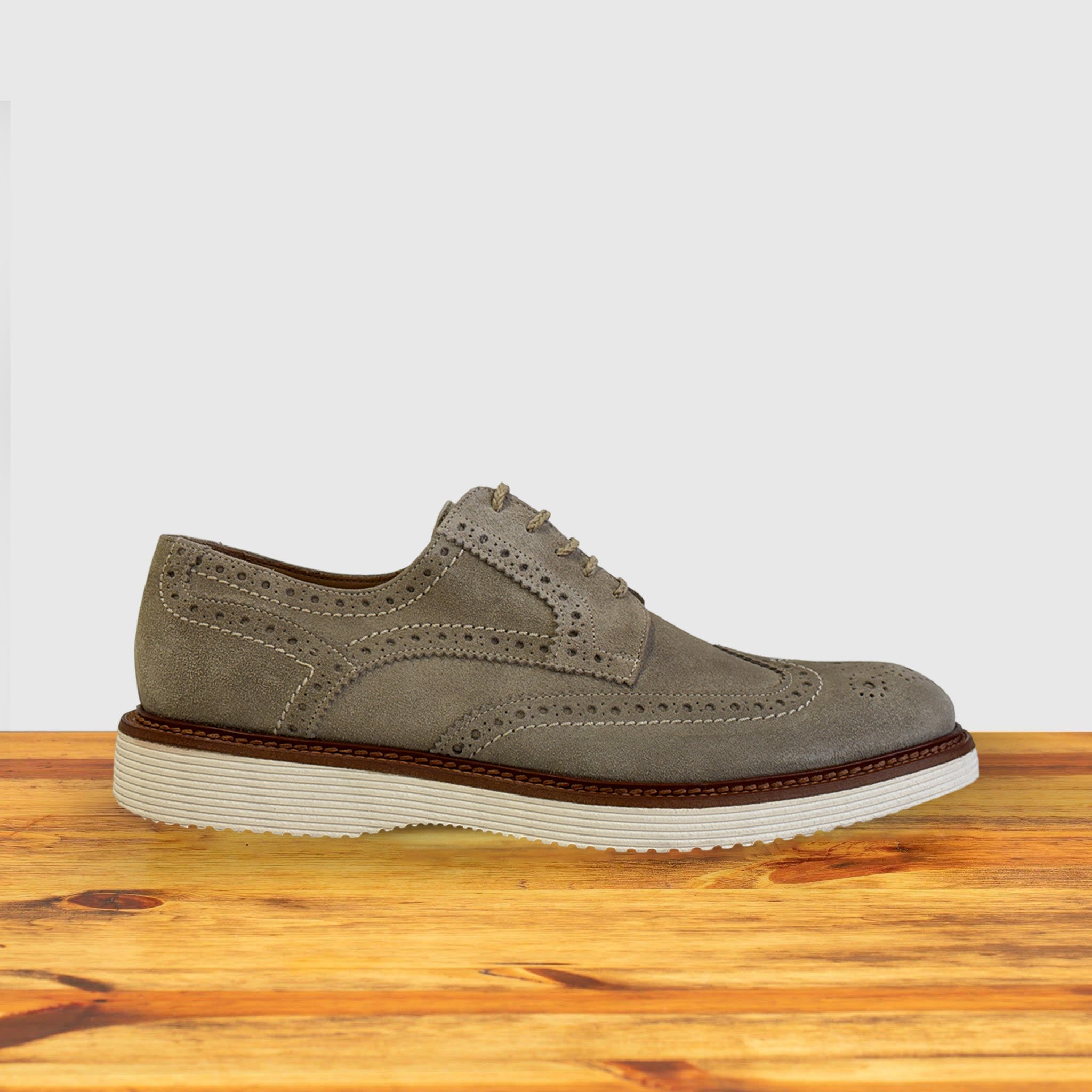 Gray suede shoe  on a wooden surface