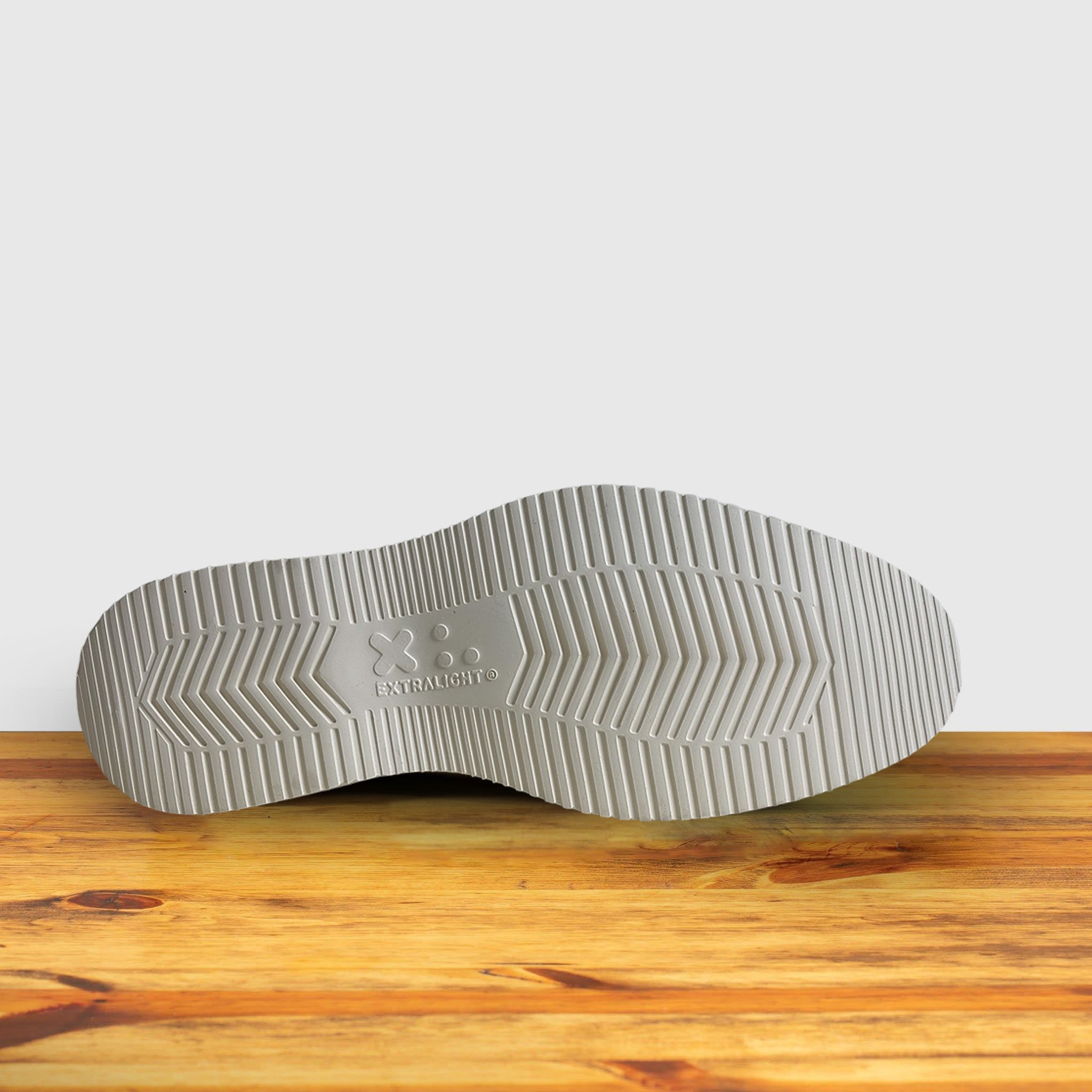 Back of Gray suede shoe  on a wooden surface