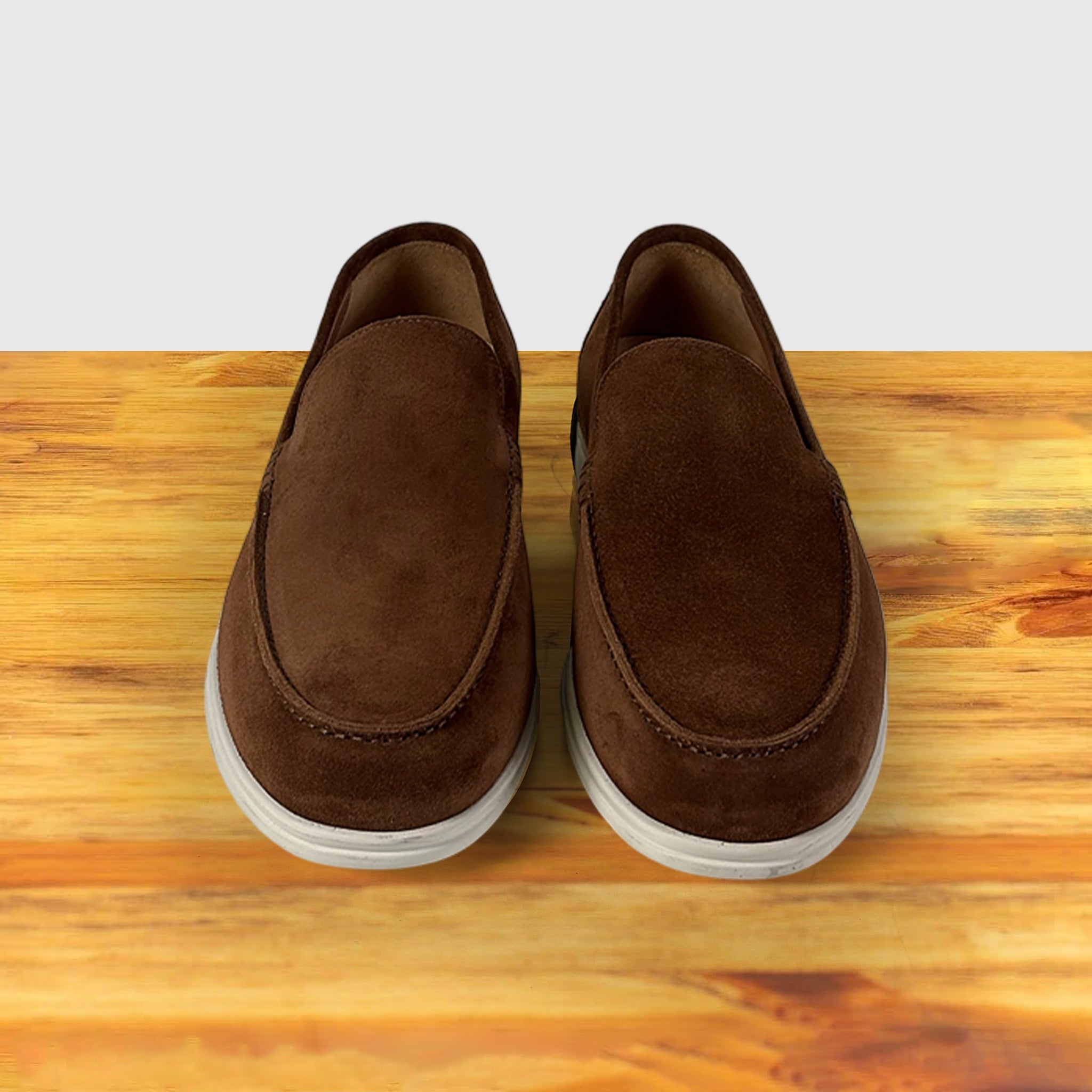 A Brick Pair of Loafers on top of a wooden surface