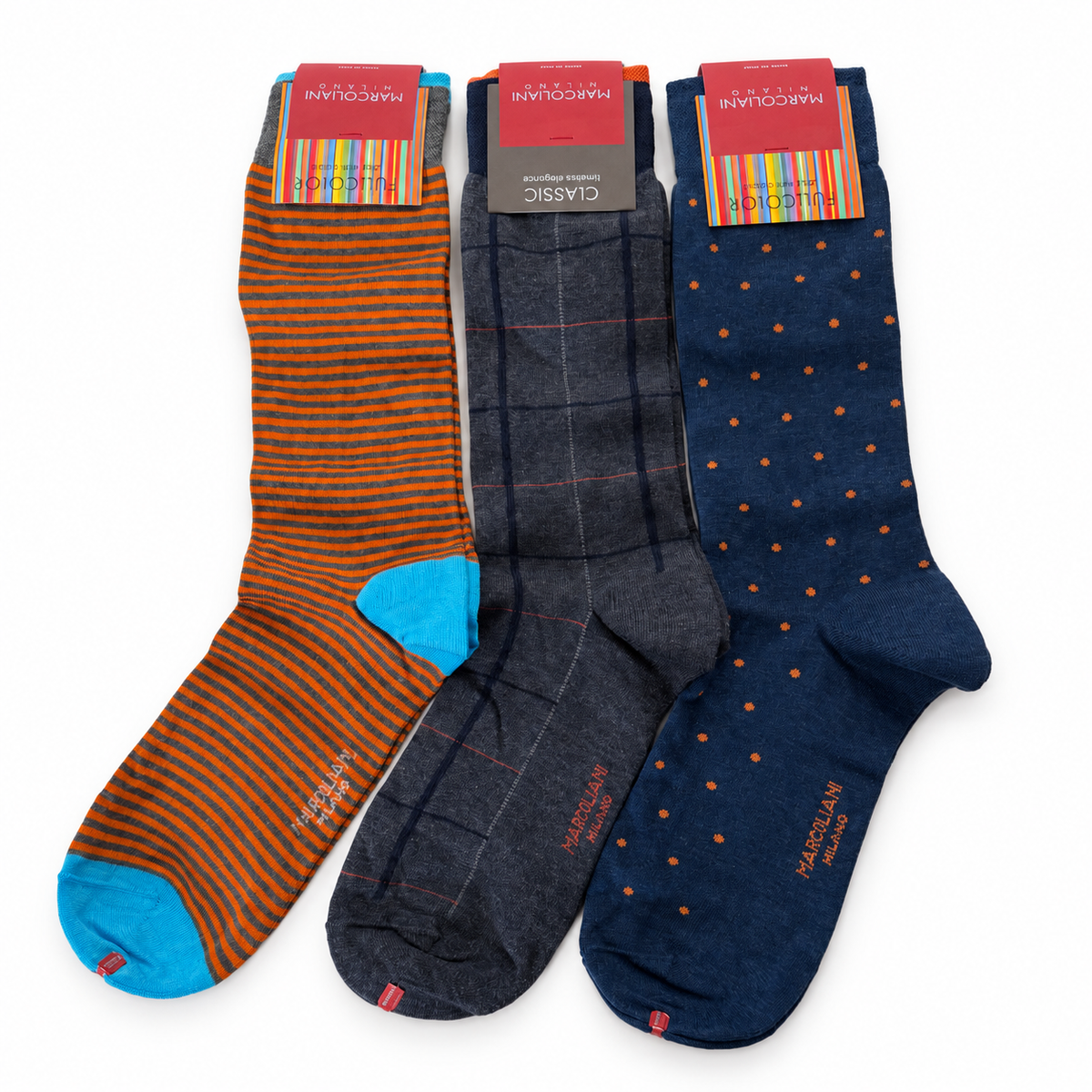 Three pairs of Marcoliani dress socks: orange and gray stripes with turquoise heels and toes, charcoal gray plaid, and navy with small orange dots.