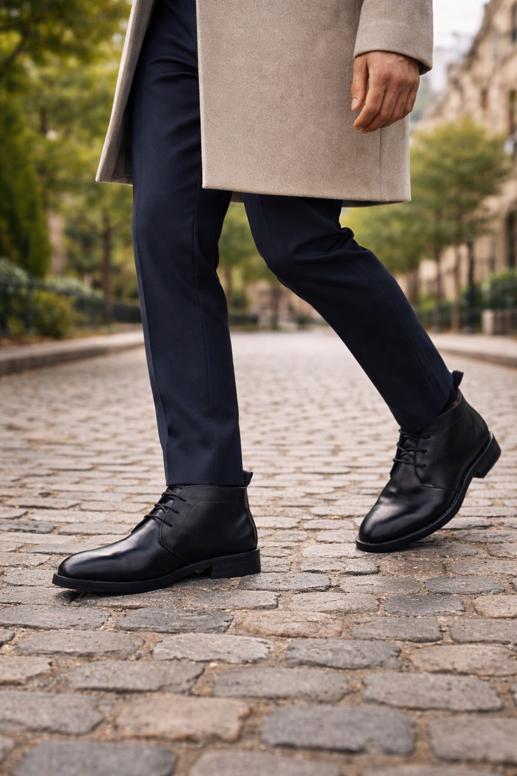 Person wearing black leather shoes on a cobblestone street
