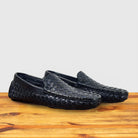 Pair of Navy Blue loafer shoe with woven pattern on a wooden surface