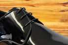 Black shiny dress shoe on a wooden surface