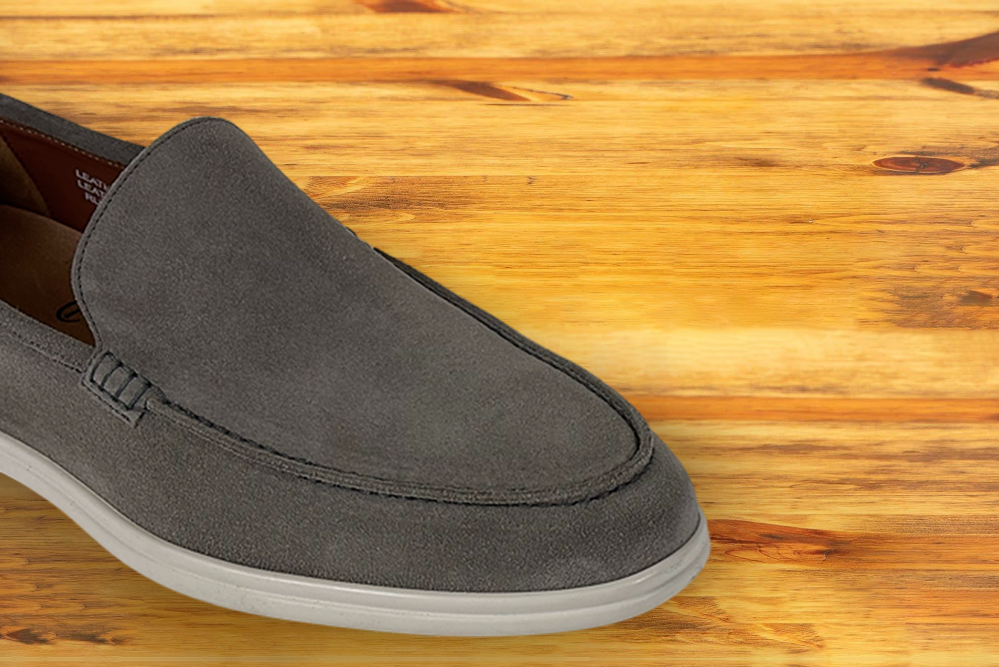 Gray loafer shoe on a wooden surface