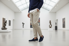 Person wearing navy loafers in a modern art gallery