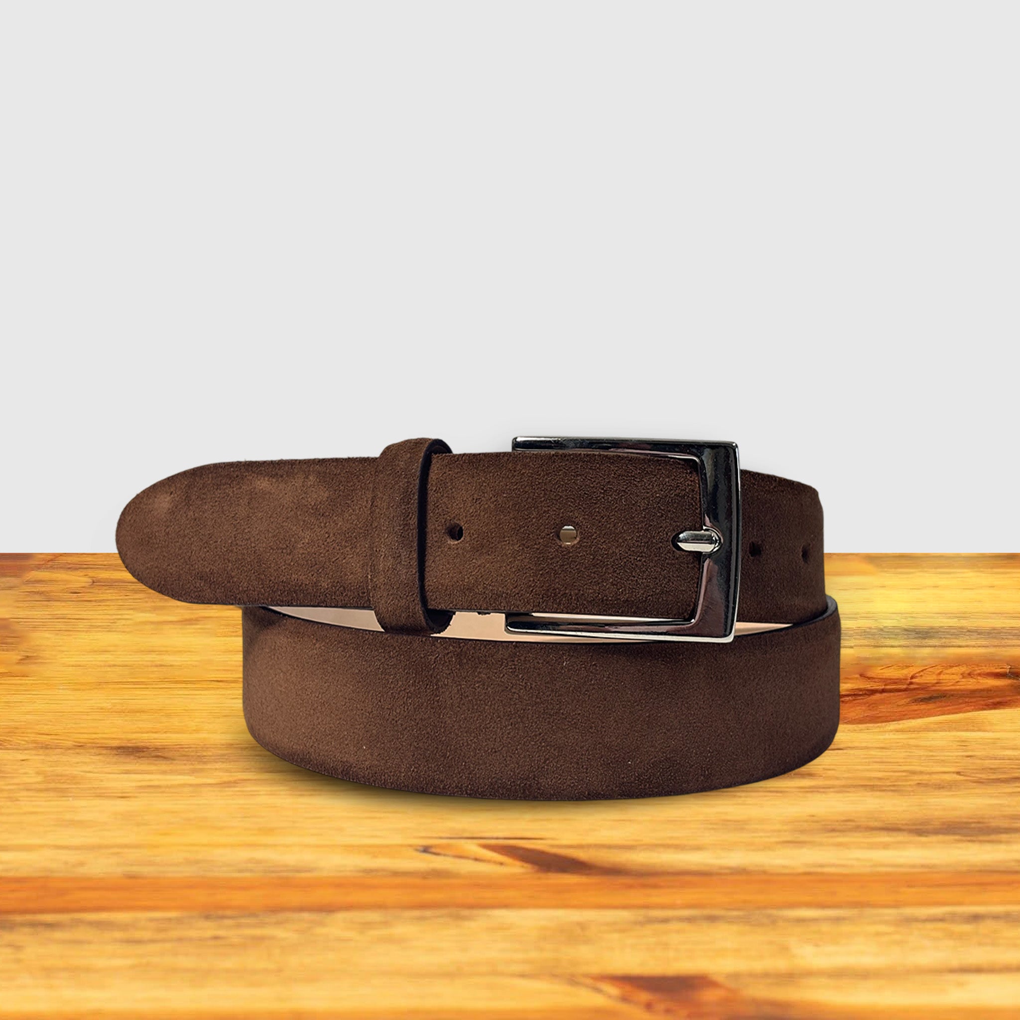 Brick belt with a silver buckle on a wooden surface