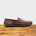 Moor loafer shoe with woven pattern on a wooden surface