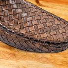 Close-up of Moor loafer shoe with woven pattern on a wooden surface