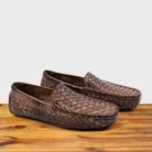 Pair of Moor loafer shoe with woven pattern on a wooden surface