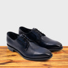 A Pair of Blue leather dress shoe on a wooden surface