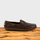 Moor leather loafer on a wooden surface with a white background