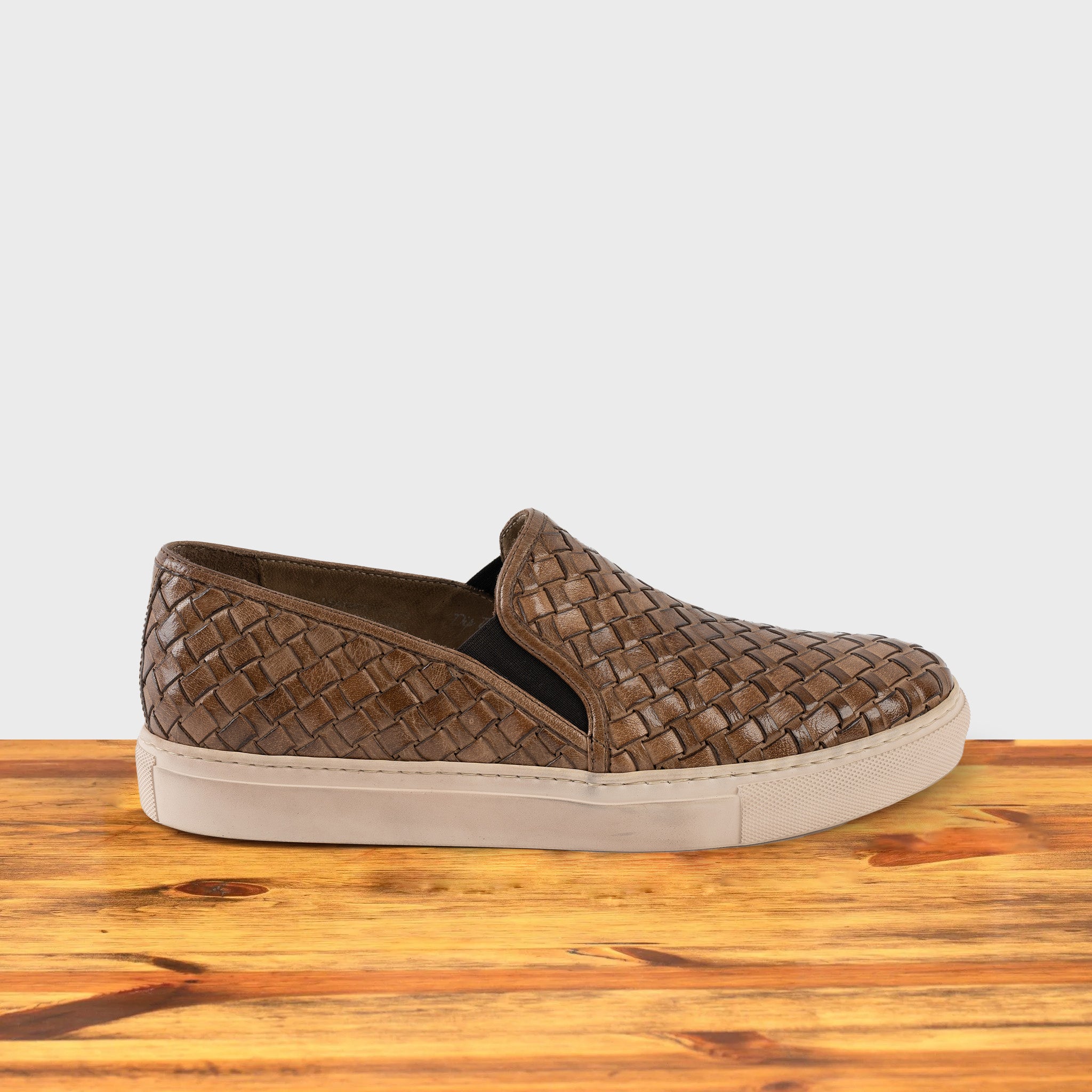 Moor woven slip-on shoe on a wooden surface with a white background