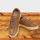 A Pair of Brick woven sneaker on a wooden surface