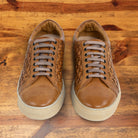 A Pair of Brick woven sneaker on a wooden surface