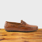 A Pair of Brick leather loafer on a wooden surface with a white background