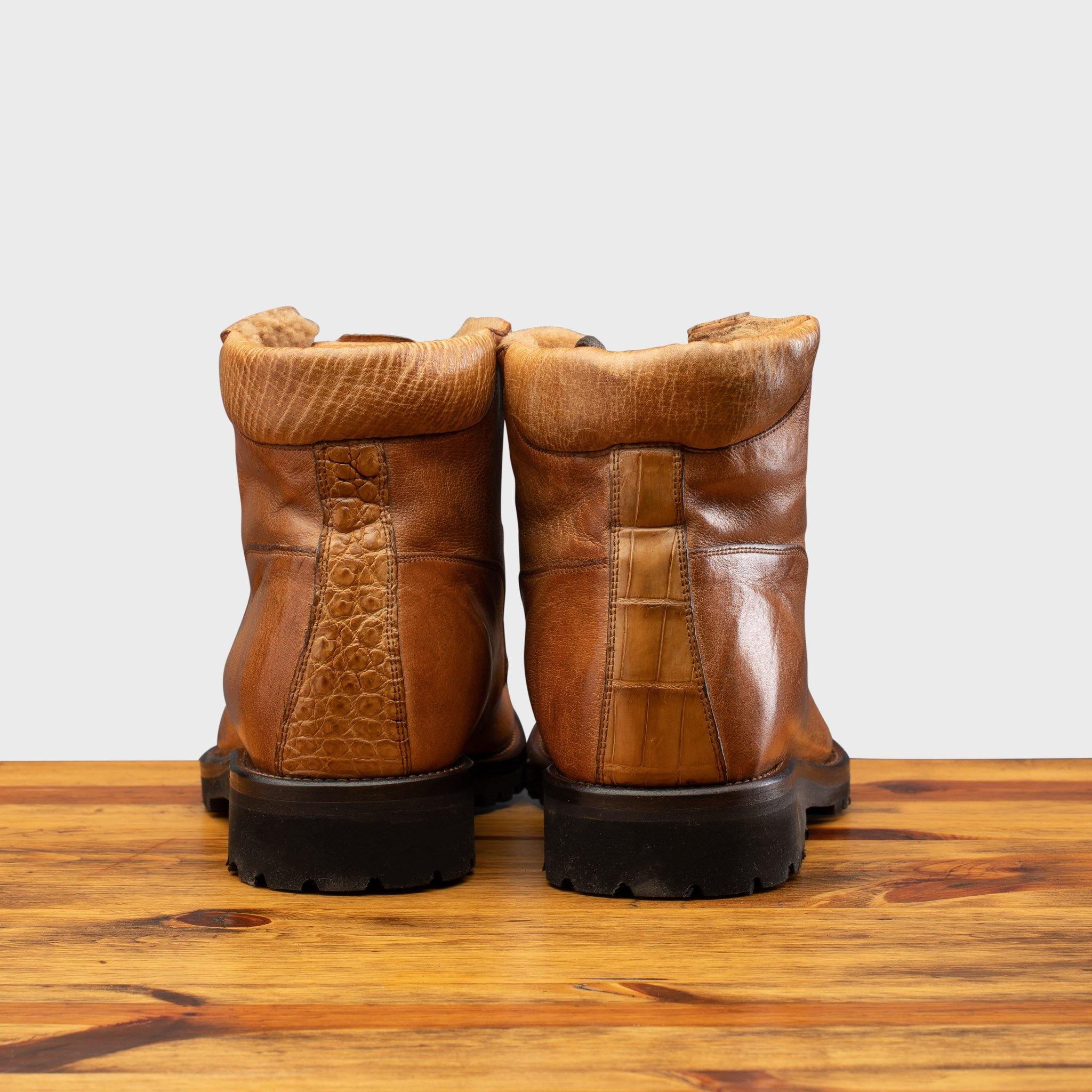 Back view of Brick leather boot on a wooden surface with a light gray background