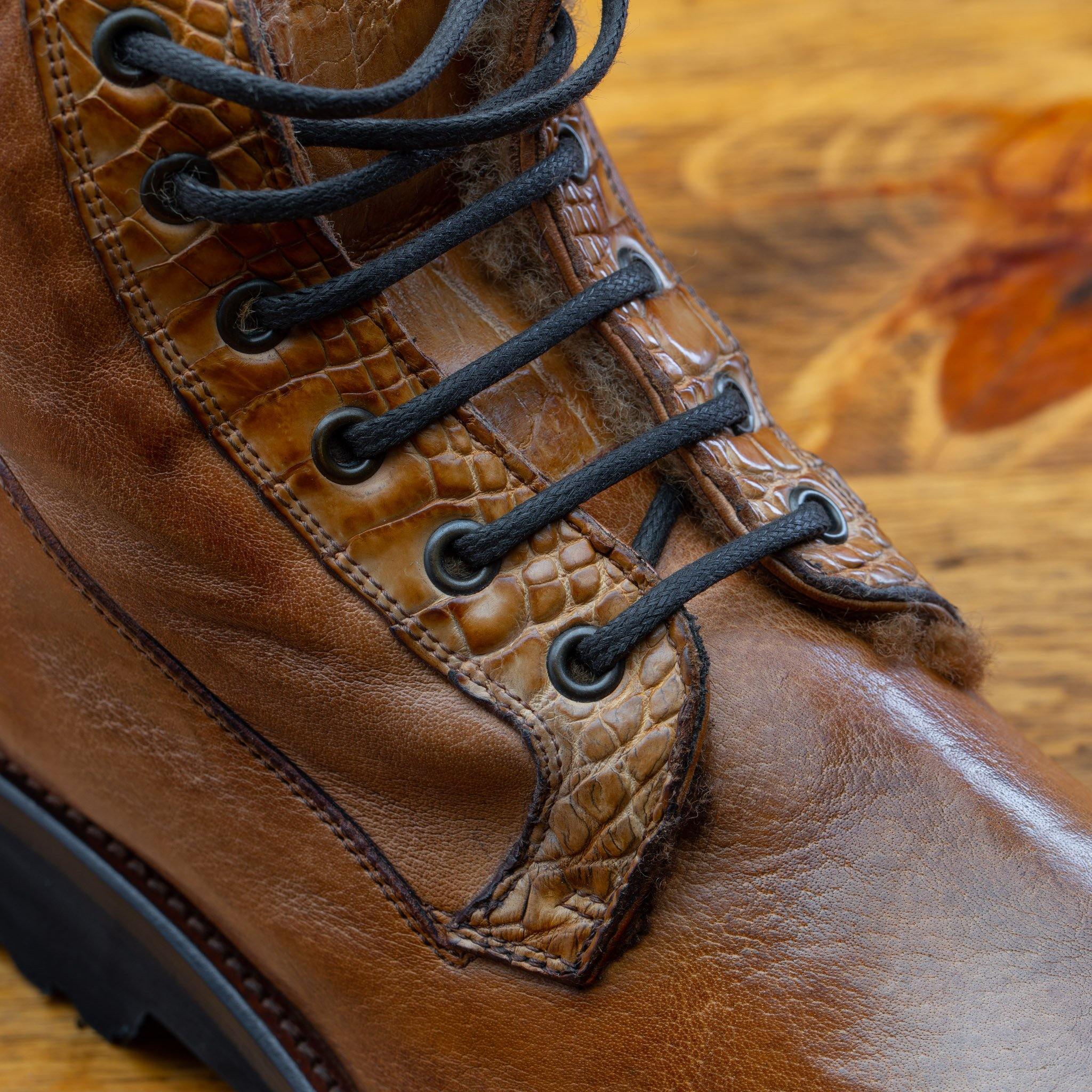 Close-up view of Brick leather boot on a wooden surface