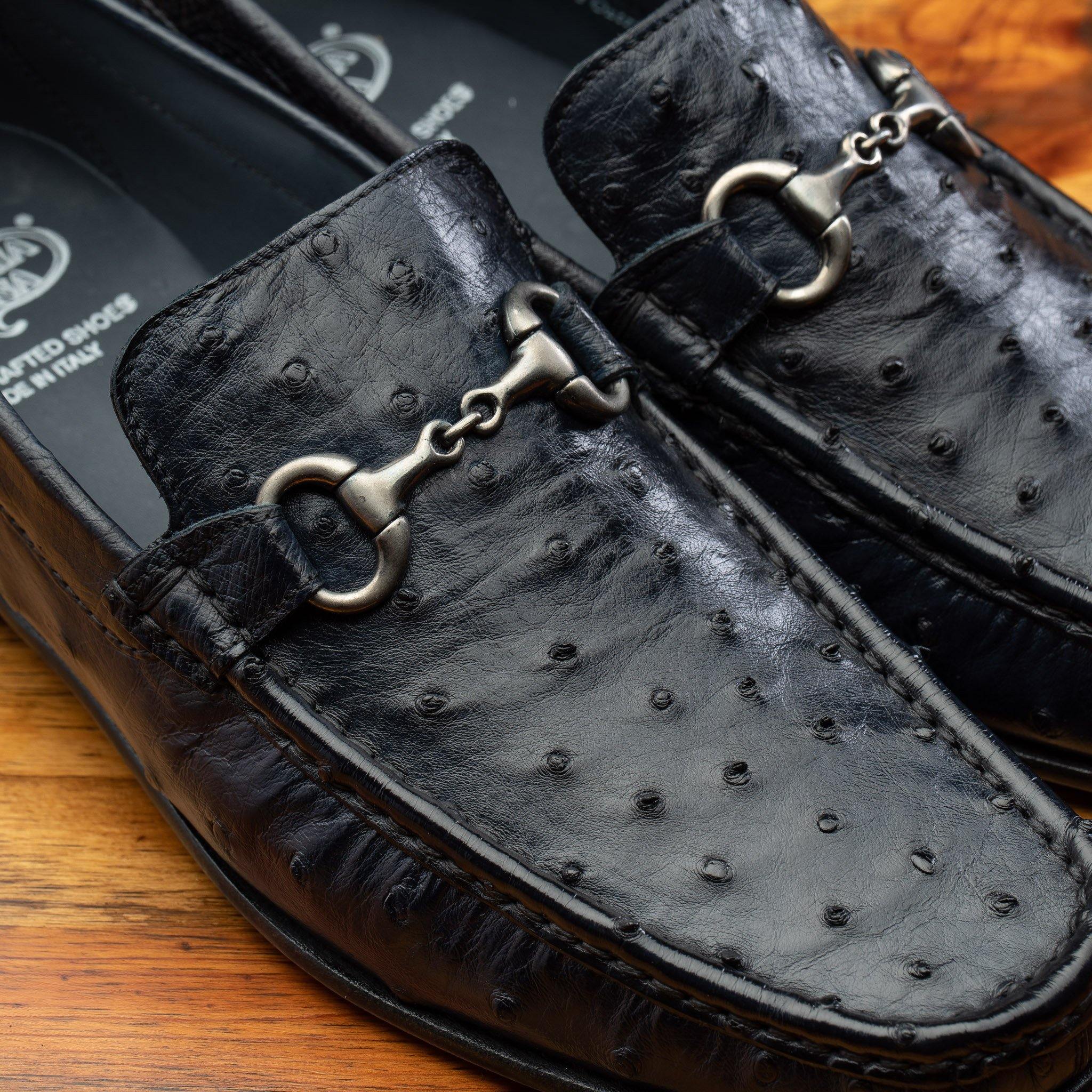 Pair of Blue leather loafer on a wooden surface