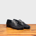 Pair of Blue loafer shoe on a wooden surface with a light gray background