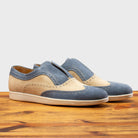Pair of Two-tone shoe with beige and blue design on a wooden surface