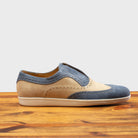Two-tone shoe with beige and blue design on a wooden surface