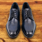 A Pair of Blue leather dress shoe on a wooden surface