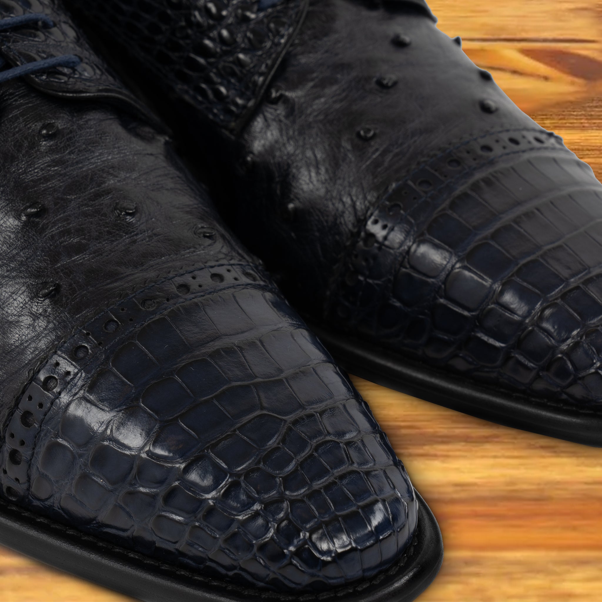 A Pair of Blue pstrich  dress shoe with studded details on a wooden surface