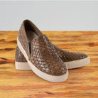 A Pair of Moor woven slip-on shoe on a wooden surface with a white background