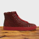 Cherry high-top sneaker with woven pattern on a wooden surface