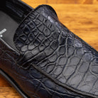 Close view of Blue leather loafer on a wooden surface