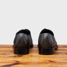 A Pair of Emerald leather dress shoe on a wooden surface with a light gray background