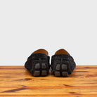 A Pair of  Black loafer with gold embroidery on a wooden surface